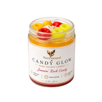 Jar of candy-themed candle with colorful candies on a white background